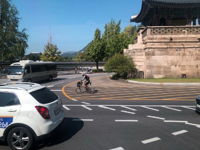 A person cycling in street traffic