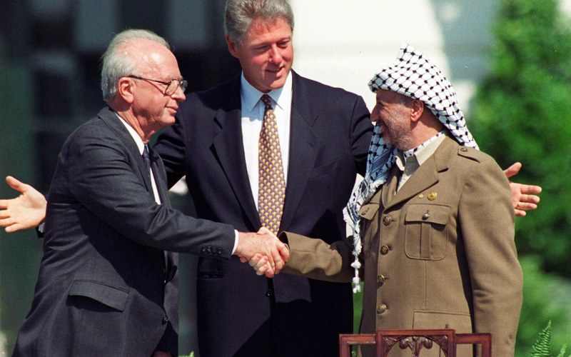  Israeli Prime Minister Yitzhak Rabin, left, and Palestinian leader Yasser Arafat shake hands marking the signing of the peace accord between Israel and the Palestinians, in Washington, Sept. 13, 1993