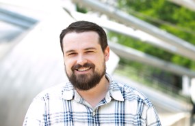 Council expert AJ Caughey is pictured outside in a plaid shirt looking into the camera smiling