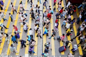 City crosswalk busy with pedestrians.