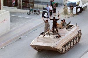 Militant Islamist fighters take part in a military parade.