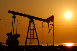 View of an oil rig in front of sunset.