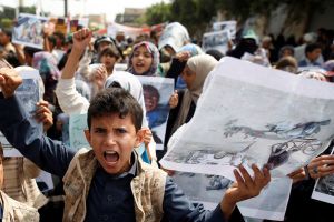 Boys demonstrate outside the offices of the United Nations in Sanaa, Yemen to denounce last weeks air strike that killed dozens including children in the northwestern province of Saada