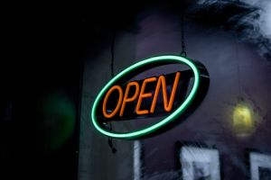 An illuminated OPEN sign outside of a business