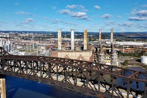 Industrial city skyline and bridge with blue clouds. 