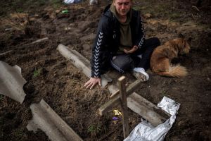 Man mourning over grave.