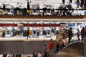 People go up an escalator in a Chinese department store