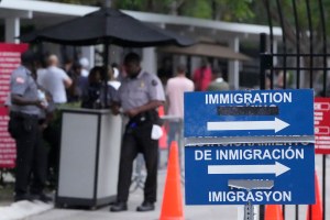 Officers stand outside the Immigration and Customs Enforcement (ICE) office