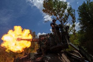 Ukrainian soldiers fire by 2s7 self-propelled howitzer towards Russian positions