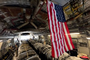 Containers of US humanitarian aid are loaded inside an Air Force airplane