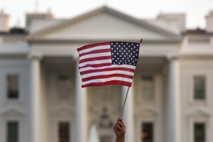 An American flag is waved outside the White House