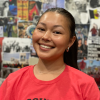 Jayden Lim is pictured from the shoulders up wearing a red t-shirt, smiling into the camera.