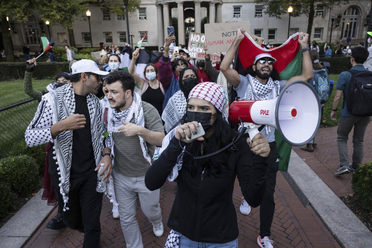 protesters holding flag and megaphone