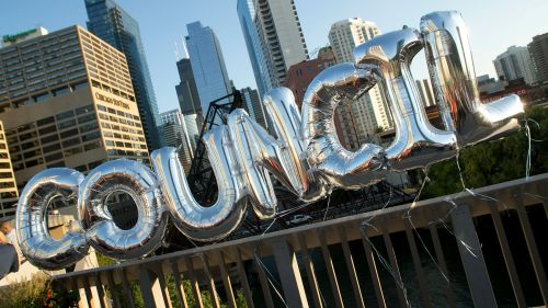 Silver balloons spelling out Council, with the Chicago skyline in the background.