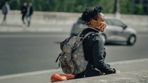 A person in a face mask walks in Pont de Sully, Paris, France.