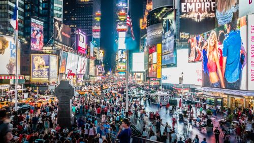 A crowded Times Square at night time