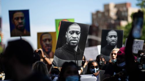 Protestors hold signs during a demonstration after the death of George Floyd.