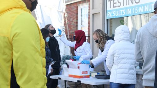 People stand outside at a a COVID testing facility