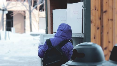 a hungry child visits an outdoor food pantry during COVID-19