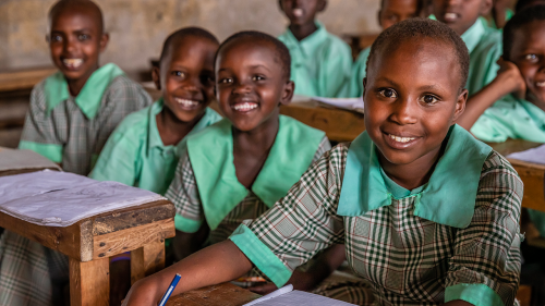 A group of girls sit at their desks at a school in Kenya.