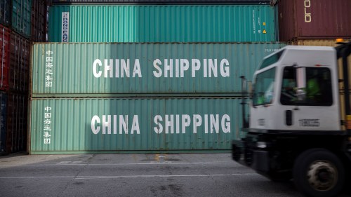 a jockey truck passes a stack of 40-foot China Shipping containers at the Port of Savannah 