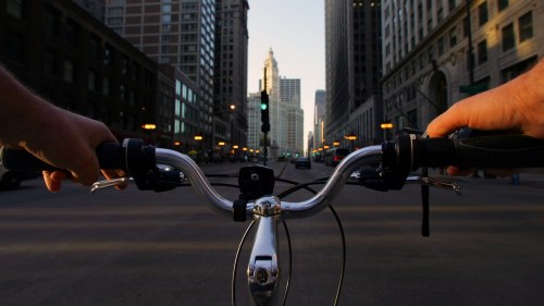 Tall buildings in Chicago behind bike handlebars