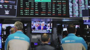 Traders at the New York Stock Exchange watch President Trump