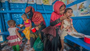 Mothers and their children at a center for Rohingya refugees in Bangladesh