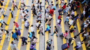 City crosswalk busy with pedestrians.