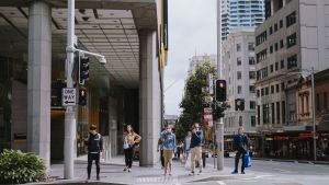 People waiting at a cross walk during a coronavirus lockdown