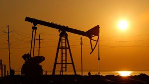 View of an oil rig in front of sunset.