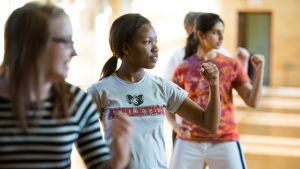 A group of young women taking a self defense class