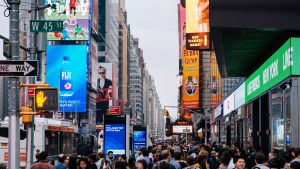 People walk through a busy Times Square in New York City.