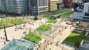 Aerial view of people in a park in front of city buildings