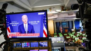 U.S. President-elect Joe Biden is seen making remarks on his plan to fight COVID-19 on a television monitor from the White House Briefing Room, in Washington