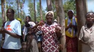 A group of people sing and clap their hands