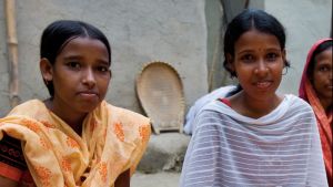 Two young girls sitting down to eat