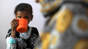 A malnourished girl receives food aid in Yemen 