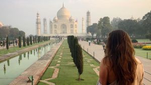 A person stands in front of the Taj Mahal