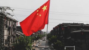 The flag of China, with a gray sky in the background