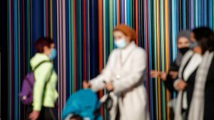 Women wearing protective face masks walk at the financial and business district of La Defense, amid the outbreak of the coronavirus disease (COVID-19), in Paris, France, November 9, 2020.