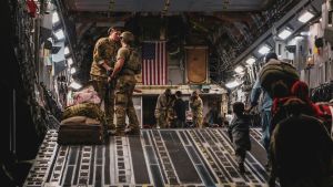 Soldiers and civilians boarding an evacuation plane out of Afghanistan.