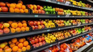 A shelf of fresh produce at a grocery store