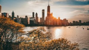 The Chicago skyline, with Lake Michigan in the foreground, at sunset