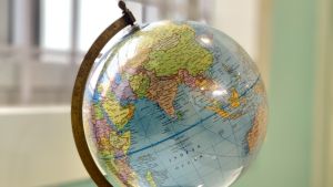 A globe sitting on a table, showing the continent of Asia