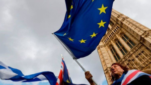 An anti-Brexit protester holds a European Union flag outside the Houses of Parliament in London