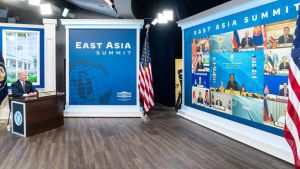 Biden seated at a desk in facing the teleconference of the East Asian Summit.