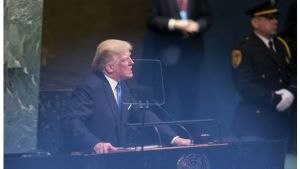 Donald Trump speaks into a microphone on podium