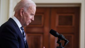 Profile shot of President Joe Biden at a podium. 