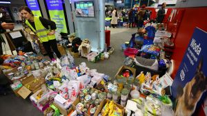 Volunteers distribute food for animals carried by Ukrainian refugees fleeing the Russian invasion of Ukraine, at a train station in Krakow, Poland.